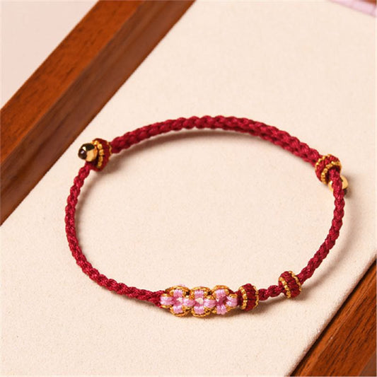 Antikes tibetisch-buddhistisches Armband aus rotem Seil mit Pfirsichblütenmotiv und Schutzmotiv