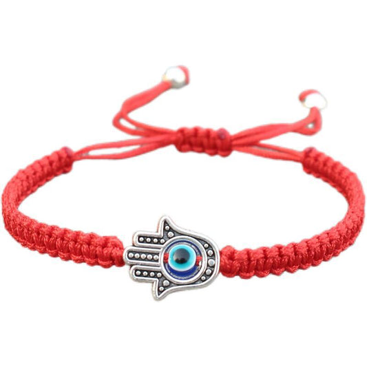 Alte tibetisch-buddhistische Tradition: Handgefertigtes Armband mit rotem Faden und Hamsa-Symbol zum Schutz und Glücksbringen