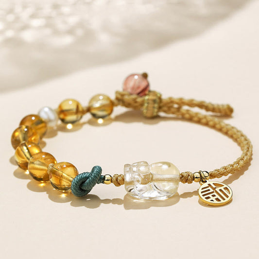 Bracelet tressé en citrine dorée, symbole de richesse et d'énergie, pour le chakra du plexus solaire (troisième chakra) et représentant le caractère PiXiu Fu de la prospérité.