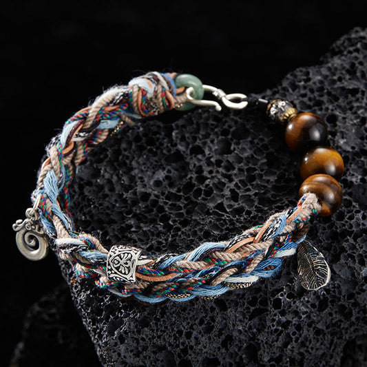 Antikes tibetisch-buddhistisches Armband aus rotem Seil, handgefertigt aus 925er Sterlingsilber mit Tigerauge-Motiv und farbenfroher Baumwolle, symbolisiert Willenskraft 