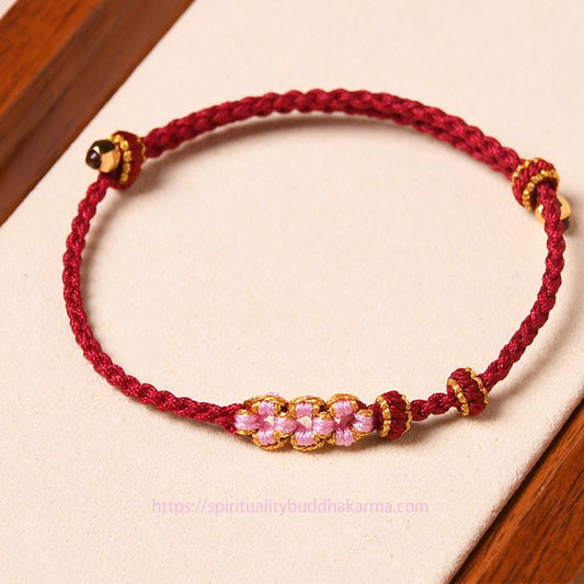 Antikes tibetisch-buddhistisches Armband aus rotem Seil mit Pfirsichblütenmotiv und Schutzmotiv
